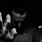 Man in despair with raised hands and bowed head 1