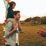 Three generations of men Photo of a three generations of men, who enjoy kite running and spending time together outdoors in the nature