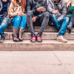 Group of friends Group of people sitting on a staircase outdoors, close up on low section body - Multiracial friends talking and having fun on a meeting outdoors